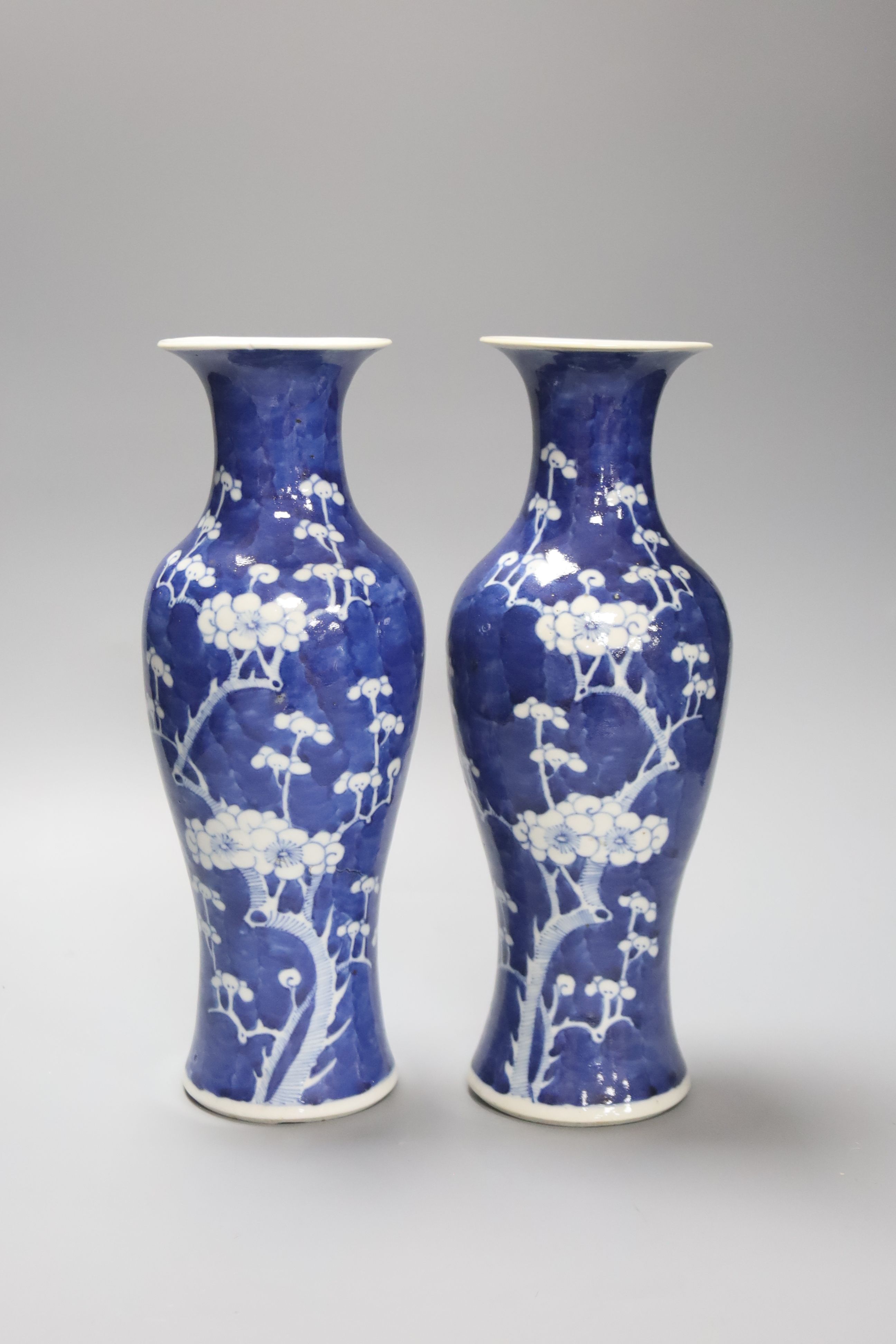 A pair of slender Chinese blue and white prunus vases, late 19th century, height 30cm